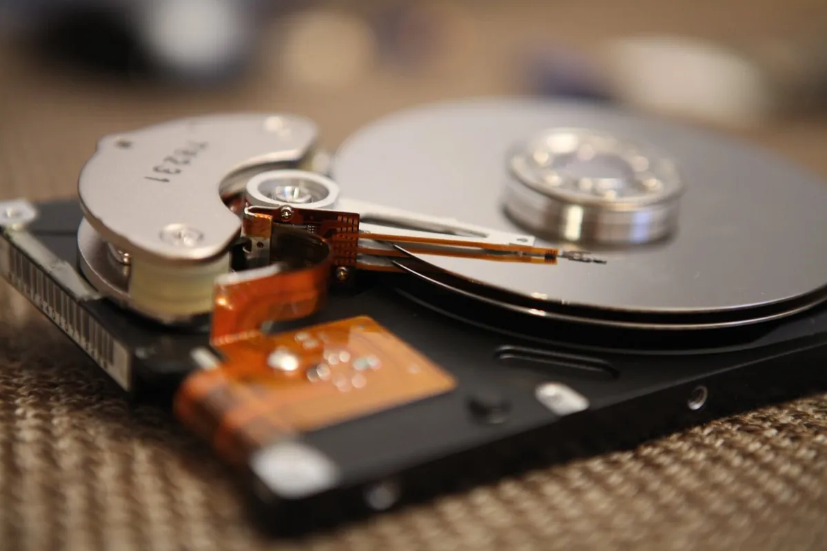 Close-up of a hard drive read head resting on the platter